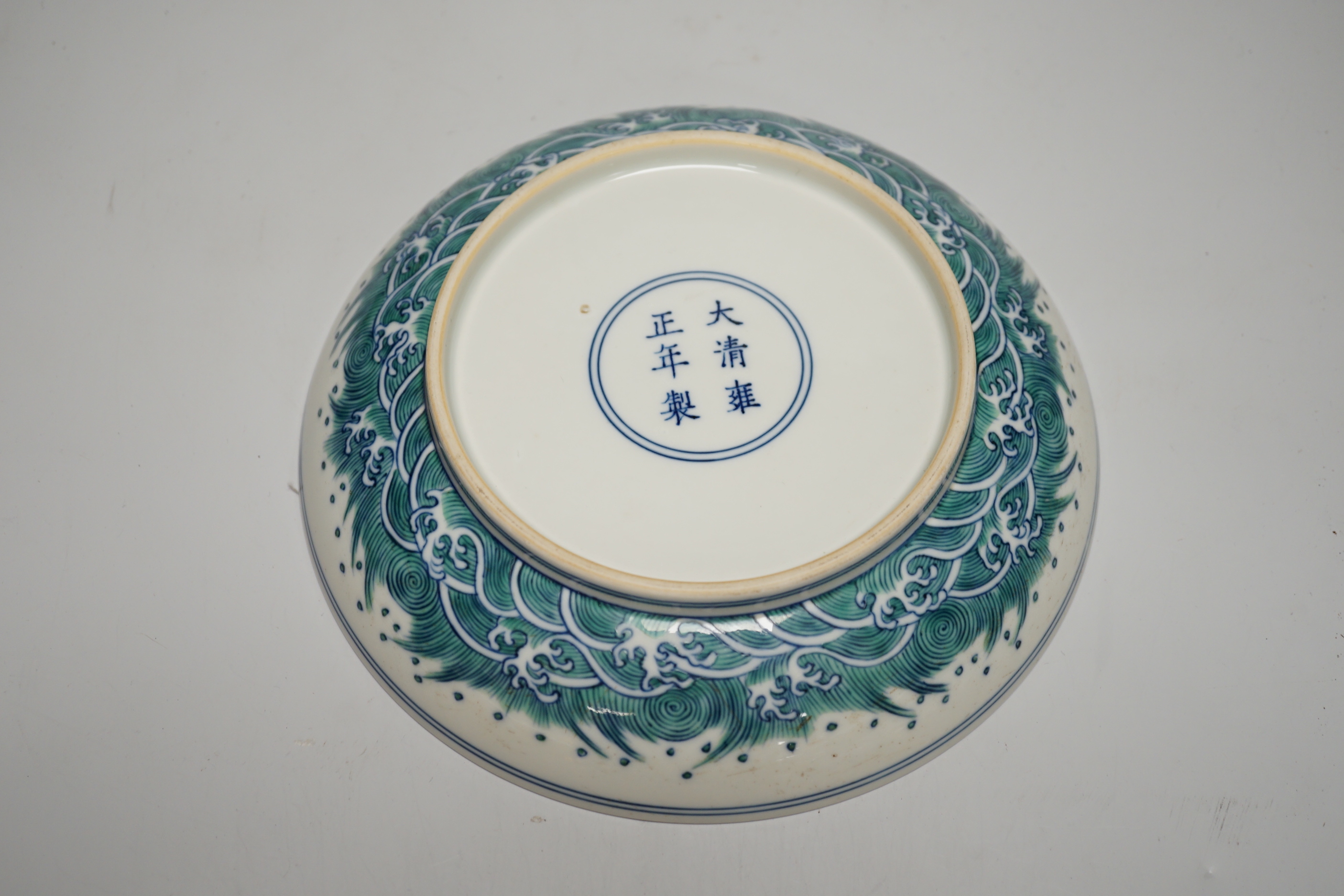 A Chinese doucai dish hand painted with a dragon chasing the flaming pearl, housed in a fitted case, 20cm in diameter